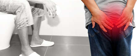 Men suffering from hemorrhoids show pain in their buttocks and problems with constipation, going to the toilet, sitting for a long time : Concept of health care, the excretory system of the bodyの写真素材