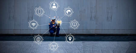 Male worker engineer using smartphone, 5G network, industrial internet system Efficient communication and connection with all devices : 5G Industrial technology concept.の写真素材