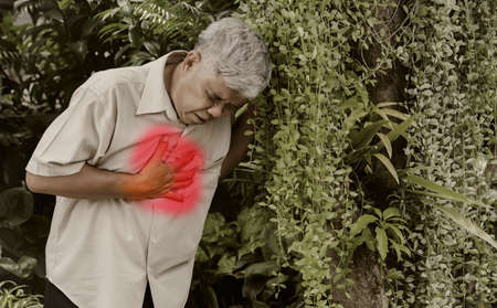 Elderly man has severe chest pain, which causes reflux of stomach acid : Old man suffers from chronic inflammatory disease of the esophagus. have chest painの写真素材