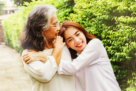 Happy family, Elderly mother and her beautiful  adult daughter are embracing the happiness, love,...
