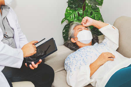 Elderly woman sleeps depressed, discouraged, tired, stressed from living, undergoes psychotherapy with a psychiatrist : Men's psychologists mentally assist elderly women for better psychotherapy.の写真素材