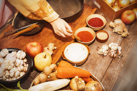 Top view Cooking Korean pickled kimchi, a Korean folk dish by a woman wearing hanbok, choosing quality ingredients for delicious symptomsの写真素材
