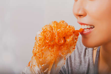 Portrait Asian women use their mouth to taste carrots through seasoning, fermentation, pickles, kimchi making, eating that taste delicious.の写真素材