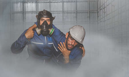 Ammonia (NH3) leak in the factory industry : Engineer urgently assisted the male technique in the refrigeration room as he could not breathe as quickly as possible before being harmed.の写真素材