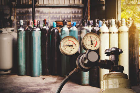 Oxygen cylinder pressure regulator and pressure gauge for safe operation are mounted on the air tank valve : Two gauge dials that show the amount of pressure in and out of the air duct.の写真素材