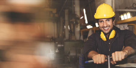 Happy portrait Indian engineer mechanic professionalOperating a metal lathe factory,works in a workshop : Technician wearing safety equipment during workの写真素材
