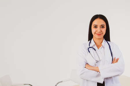 Female doctor from Southeast Asia, with strong health, standing, attitude, and medical confidence in...