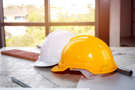 Safe working concept : Safety helmets placed on the desk : Safety helmets are placed on the desks near the waiting windows.の写真素材