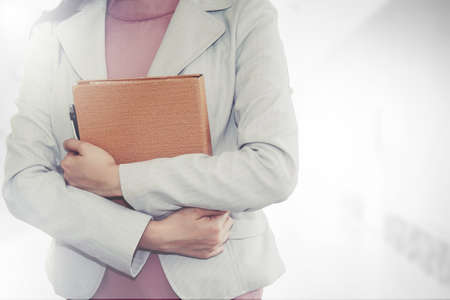 Business woman wearing a white suit, holding a document for starting a business office, the pride of a business.の写真素材