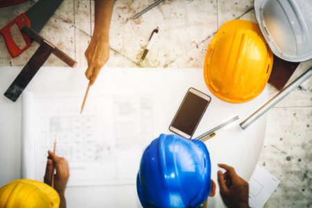 Blurry pictures Top view group of industrial architects work together on a desk to discuss building site construction projects.の写真素材