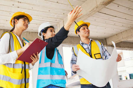 Team of engineers working together at construction site. Engineering and architecture concept.