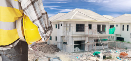 Rear view engineers or architects and village contractors look outside the construction site each...