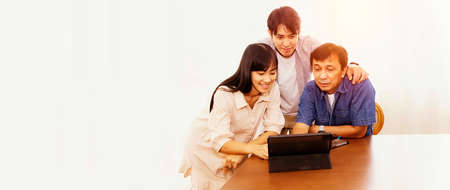 Two children teach dad social networking : Sons and daughters helping teach fathers use laptops how...