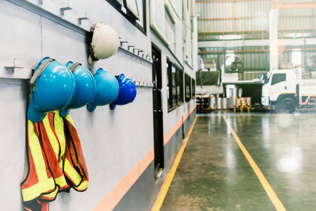 Nobogy Industrial workplaces, helmets and safety vests of supervisors and employees hang in front of the factory office shop for safety.の写真素材