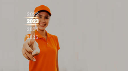 Beautiful Asian female employees wearing orange uniforms with finger prints for 2023 advertising, marketing and growth strategies : Online delivery concept.の写真素材