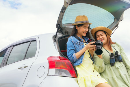 Buddy beautiful, sexy woman and her chubby girlfriend show off her back seat photo shoot as the two of them enjoyed a weekend drive together.の写真素材