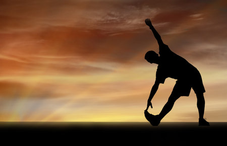Vector silhouette of a man who plays sports on a sunset background.の写真素材