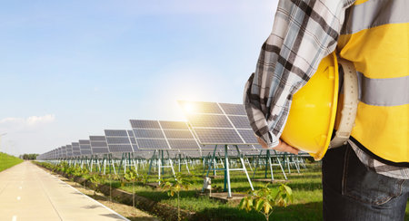 Engineer with yellow helmet and solar panel in solar power plant.の写真素材