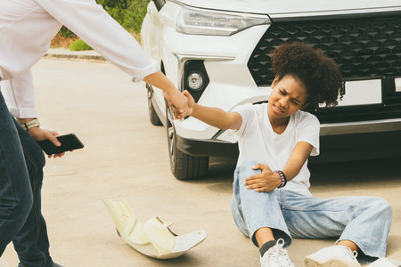 African American woman crossing road with no pedestrian crossing, causing speeding car accident, injuring her and getting help from the driver for medical treatment from the insuraの写真素材