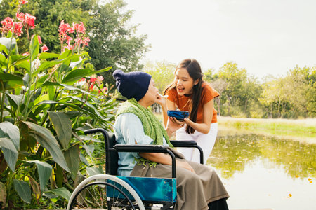 Asian family, grateful daughter takes care of mother who is sick and disabled with paralysis, feeds her food to restore her body and keep her healthy : Elderly insurance health carの写真素材