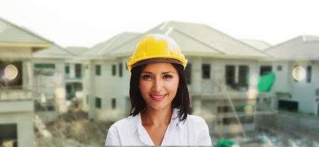 Portrait businesswoman smiling ,real estate housing project wearing helmet safety, checking construction site, project for success : Progress inspector, business woman, real estateの写真素材