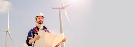 Caucasian male technician worker holding wind turbine construction blueprints exploring renewable energy industry development green energy sustainable environmentally friendly : Paの写真素材