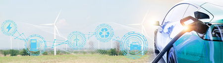 Electric car or EV blue clean energy vehicles natural resources renewable wind energy in wind farms, generating electricity to feed the charging station, environmentally friendly :の写真素材