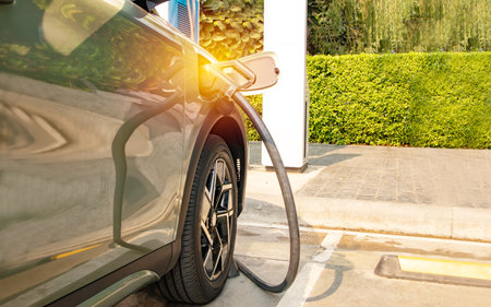 Suv EV electric car charging DC current into the vehicle battery socket fill the electric vehicle inside the public gas station, clean energy vehicles. Alternative energy is becomiの写真素材
