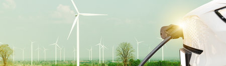 Electric car or EV clean energy vehicles natural resources renewable wind energy in wind farms, generating electricity to feed the charging station, environmentally friendly : Panoの写真素材