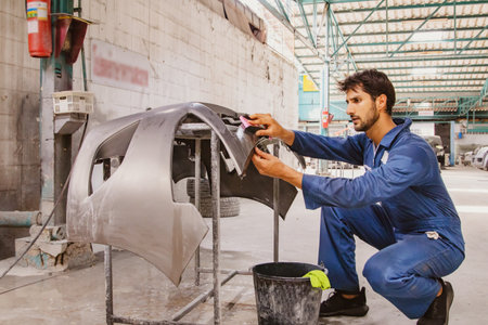 Car polishing work in the garage : Car polishing work in the garageMale car mechanic worker...