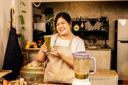 Portrait fat young Asian woman in a good mood taking care of her health, holding delicious fruit and vegetable smoothie to drink, healthy, smoothie with high nutritional value. fraの写真素材