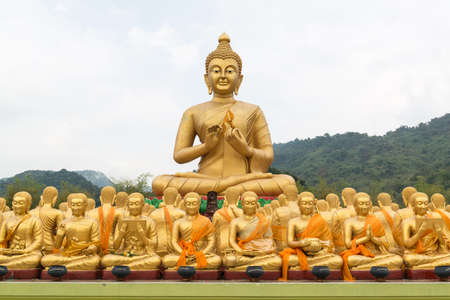 Golden buddha image and mountain backgroundの写真素材