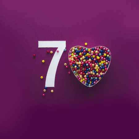 70 number seventy, creative typography with colourful balls on violet background, happy birthday,...