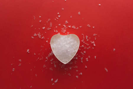 Heart with snow on red background, happy birthday, gift and love, happy Valentines day, broken heart, walentynkiの写真素材