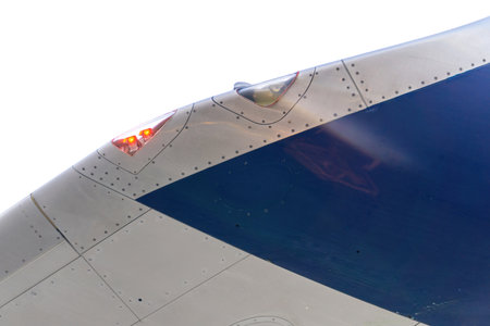 White and blue airplane wing with signal lights close up