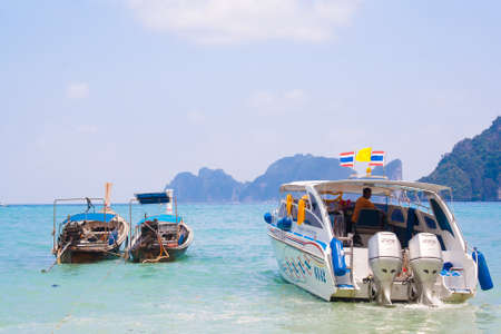 Thai longtail boats and speed boat  in Andaman Sea, Thailandのeditorial素材