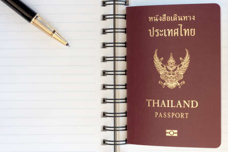 Thailand passport and pen on blank page in a spiral bound notebookの写真素材