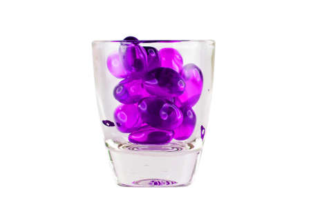 Prescription Drug Addiction Concept, tablets in shot glass isolated on white background.の写真素材