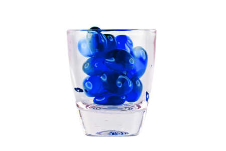Prescription Drug Addiction Concept, tablets in shot glass isolated on white background.の写真素材
