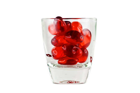 Prescription Drug Addiction Concept, tablets in shot glass isolated on white background.の写真素材