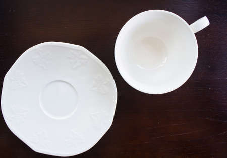 Above view of empty white coffee cup on brown wood background.の写真素材