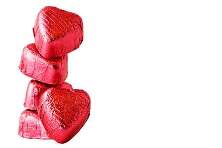 Stack of Chocolate heart candies on white background の写真素材