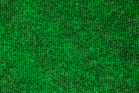 A green carpet texture, close-up の写真素材
