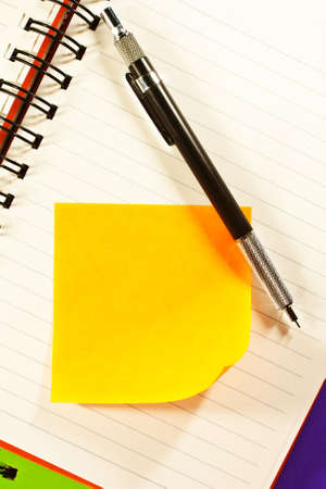 Pencil and note paper on opened blinder book