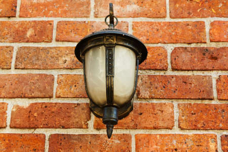 Street lamp on a textured brick wall