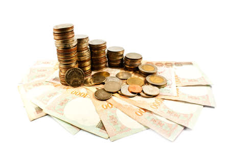 stacks of coins and cash , isolated on white backgroundの写真素材