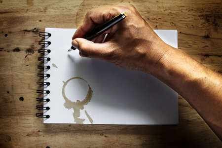 Abstract hand man writing on the grunge paper.の写真素材