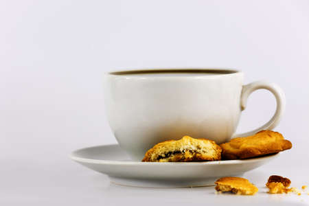 white cup of coffee with cookiesの写真素材