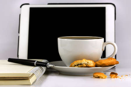 Cup of coffee,tablet computer,book and pen isolated on white background.の写真素材