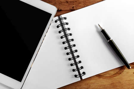 Computer screen,book and pen on wood table